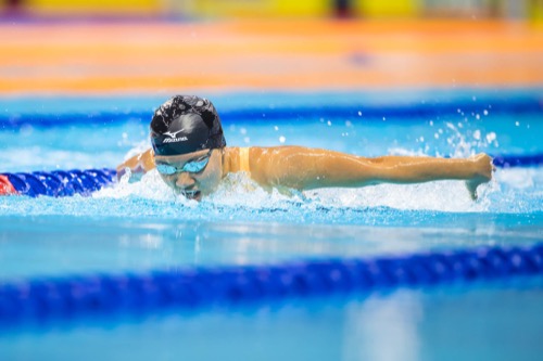 Racing the butterfly stroke at a swim meet