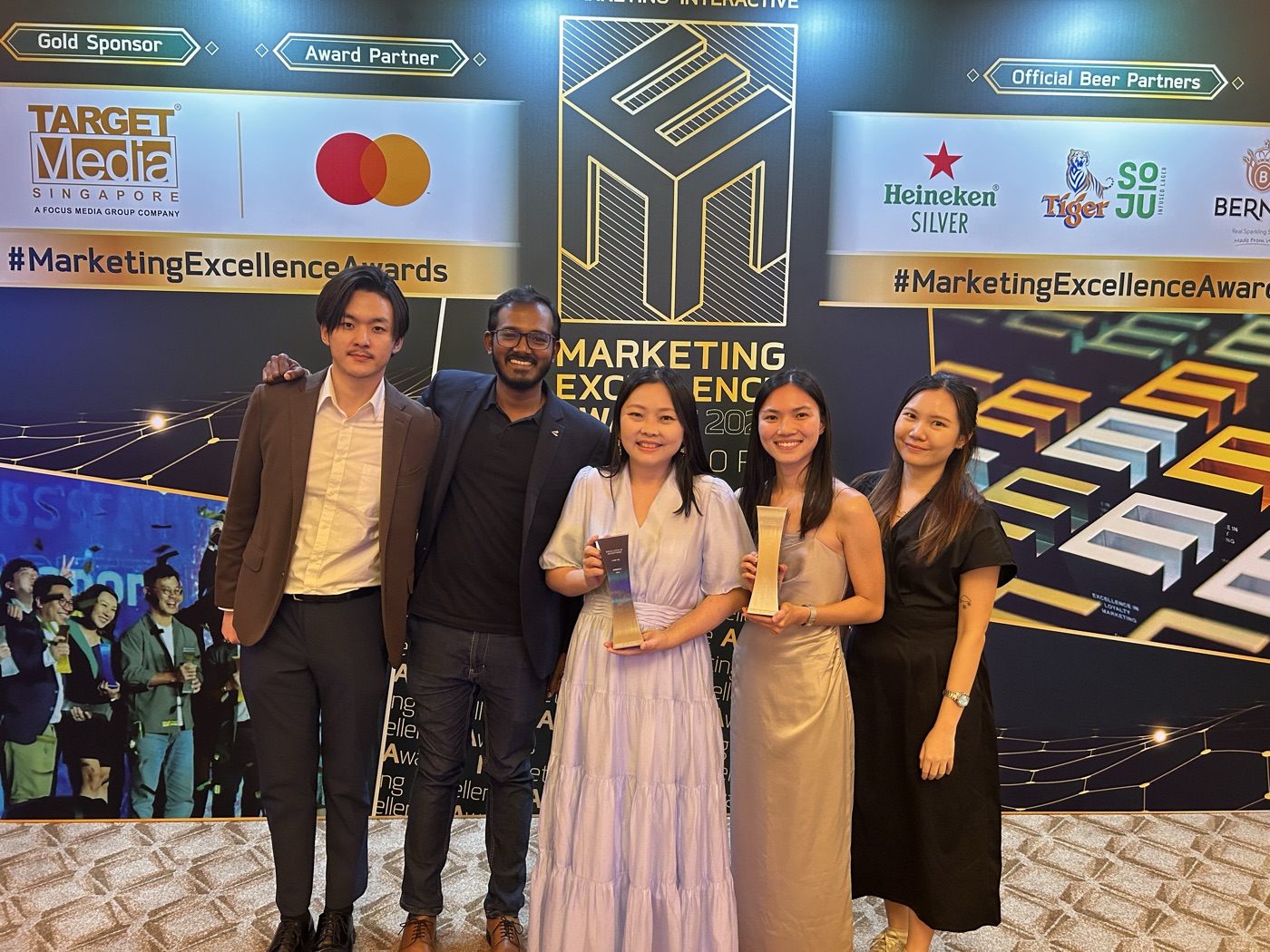Team holding trophies at the 2025 Marketing Excellence Awards