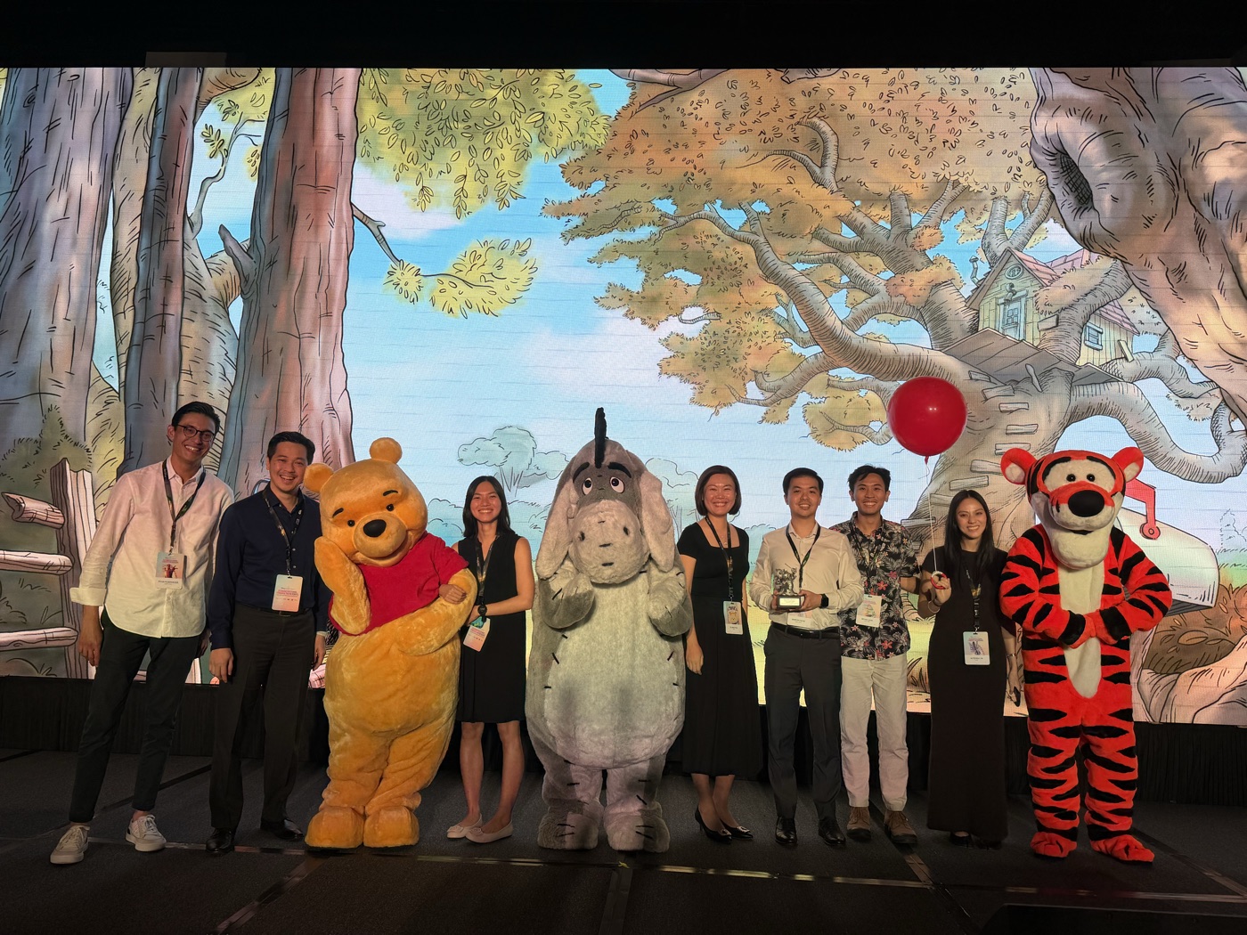 Team photo with Disney characters at an OCBC MyOwn Account event